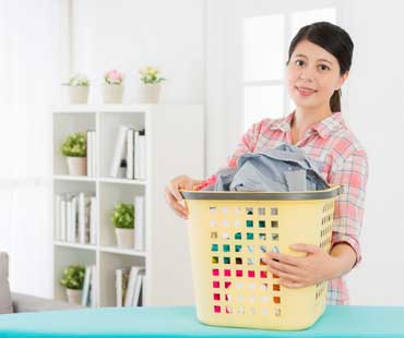 lady holding a basket of laundry