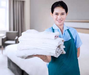 woman personally handing folded laundry